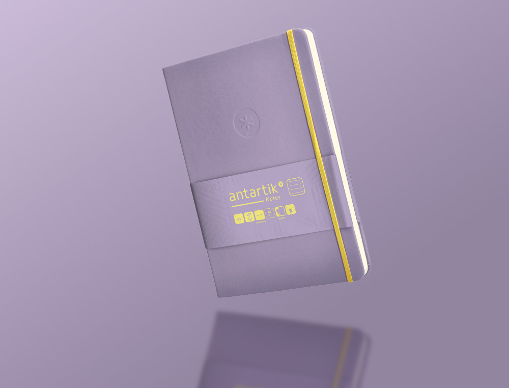 CUADERNO CON GOMILLA ANTARTIK NOTES TAPA DURA A5 HOJAS RAYAS MORADO Y AMARILLO 100 HOJAS 80 GR FSC